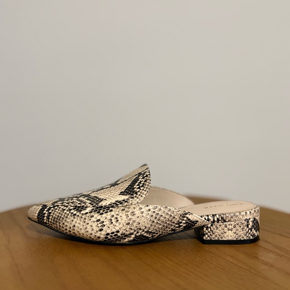 Cole Haan  mules with a snakeskin print leather upper.